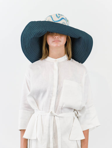 Romualda Baboomba Grande bucket hat with blue and white swirl print shown on model with brim folded up