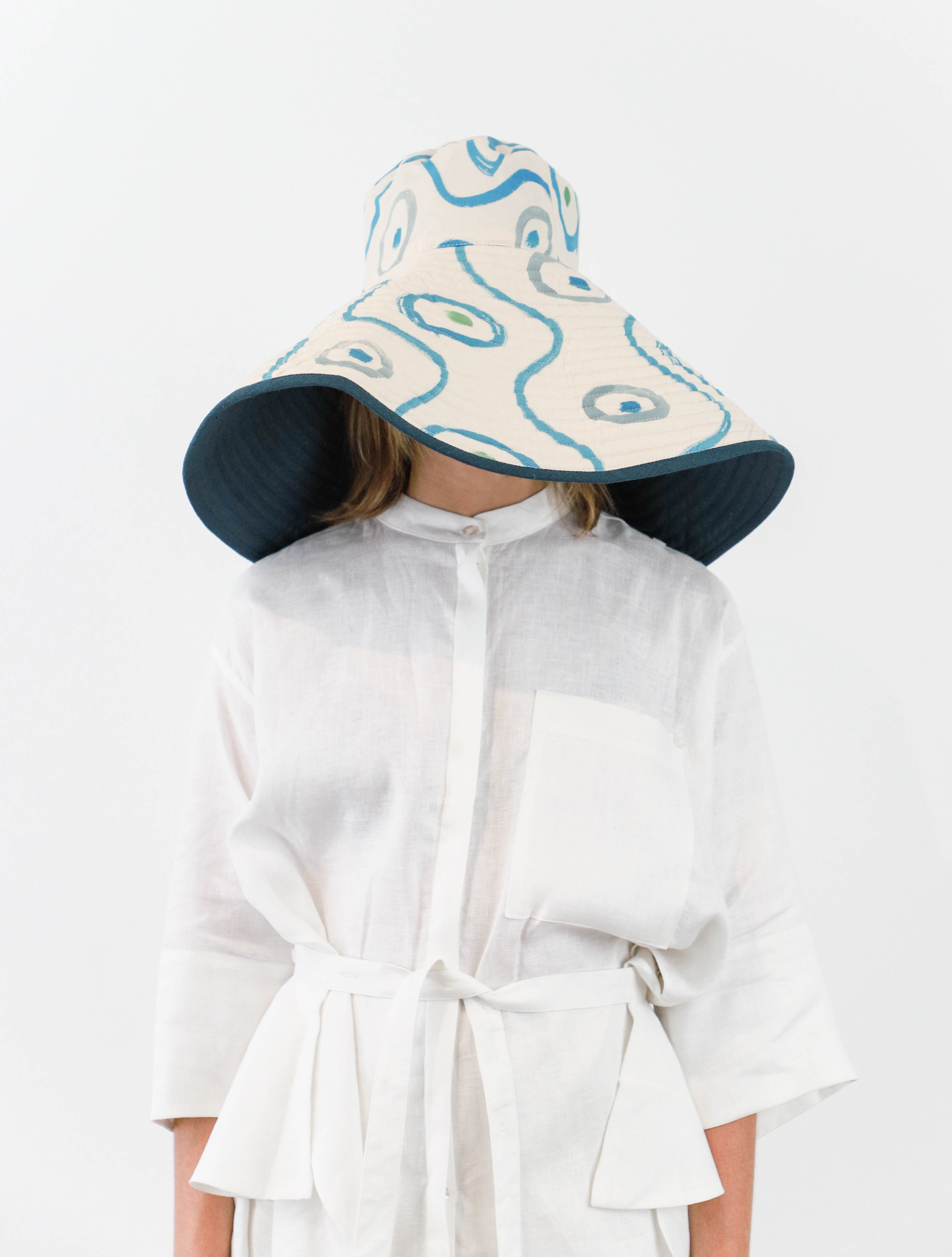 Romualda Baboomba Grande bucket hat with blue and white swirl print shown on model 